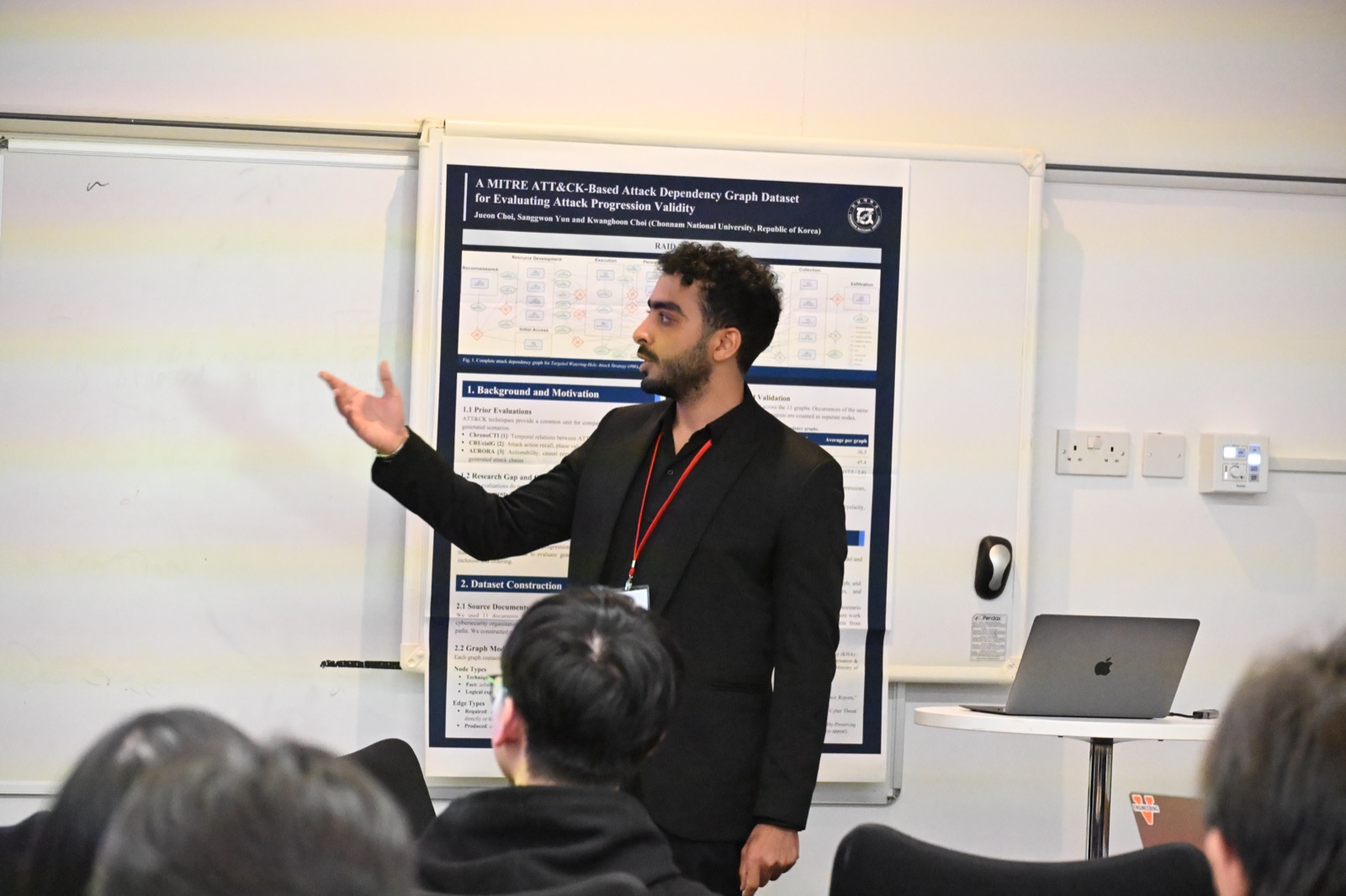 Adel ElZemity presenting at RAID 2026 in Lancaster